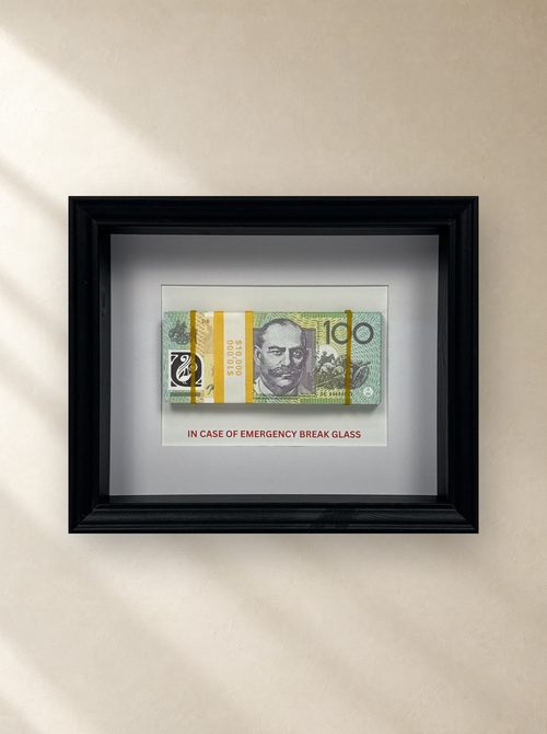 Emergency $10,000 Frame – White by Uhoh Studio on a gallery wall