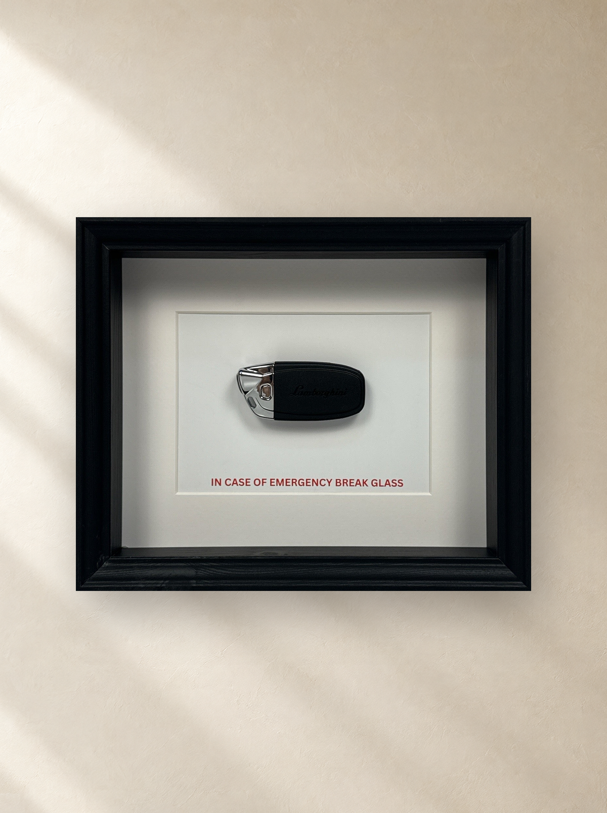Emergency Lamborghini Key by Uhoh Studio on a gallery wall