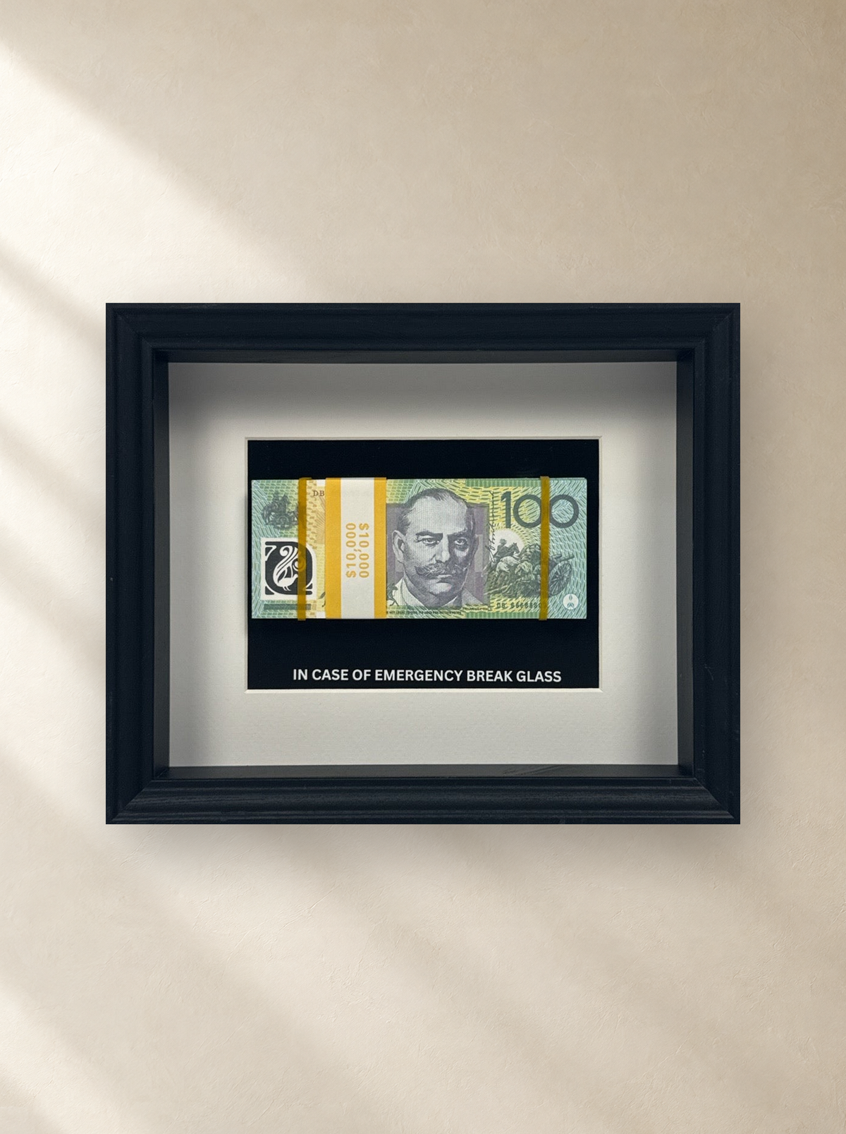 Emergency $10,000 Frame – Black by Uhoh Studio on a gallery wall